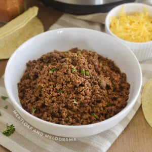 instant pot ground bee taco meat in a white bowl with cilantro