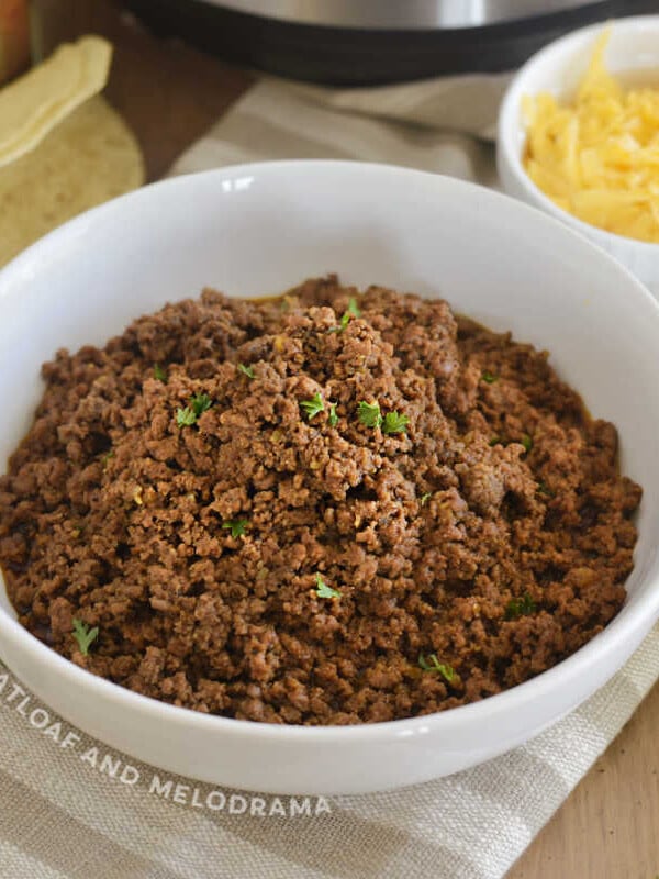 instant pot ground bee taco meat in a white bowl with cilantro
