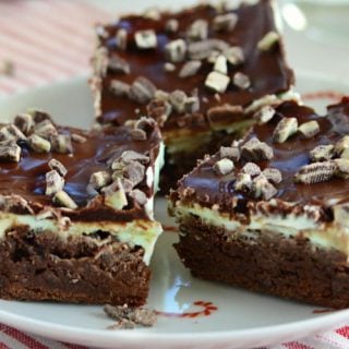 mint chocolate chip brownies topped with andes mints on a candy cane plate