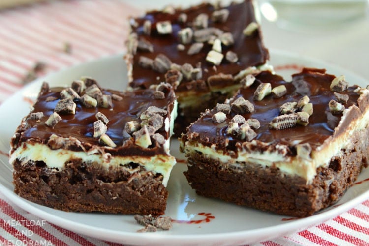 mint chocolate chip brownies topped with andes mints on a candy cane plate