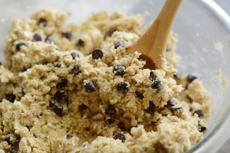mix oatmeal chocolate chip cookie bars dough in glass bowl