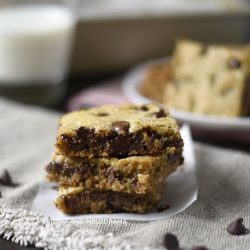 easy oatmeal chocolate chip cookie bars stacked with milk