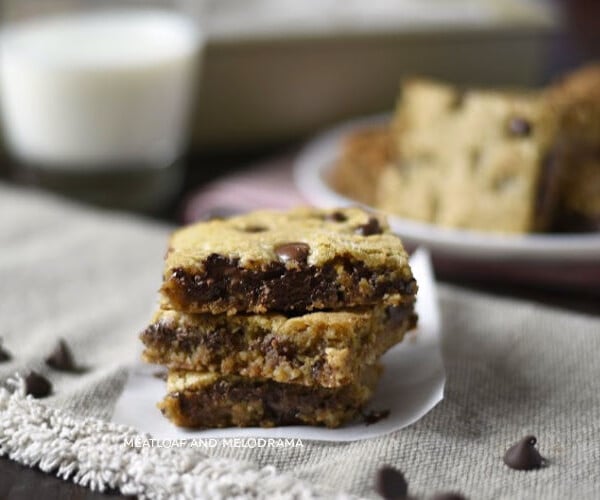 easy oatmeal chocolate chip cookie bars stacked with milk