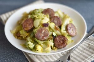 pan fried kielbasa and cabbage on a white plate