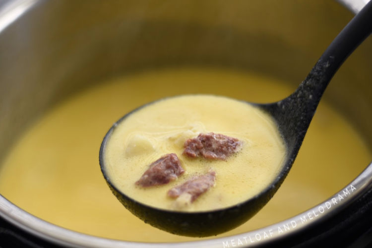 instant pot cheesy potato soup with kielbasa in ladle