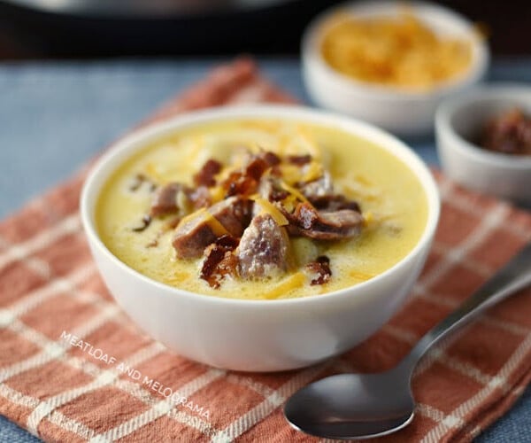 instant pot potato soup with kielbasa cheddar cheese and bacon in white bowl