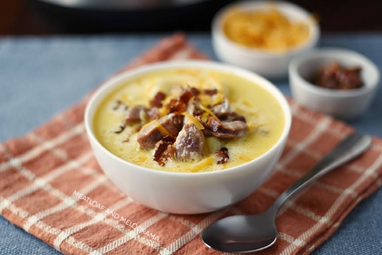 instant pot potato soup with kielbasa cheddar cheese and bacon in white bowl 