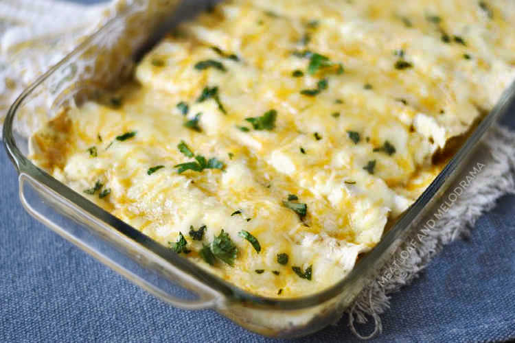 instant pot creamy chicken enchiladas with salsa verde in a baking dish with cheese and cilantro