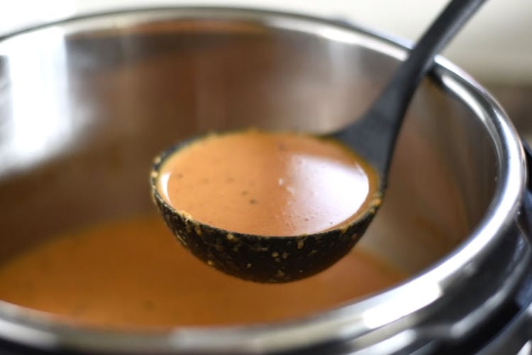 instant pot creamy tomato basil soup in ladle