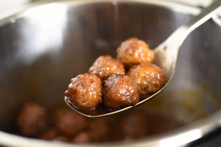 grape jelly meatballs on spoon