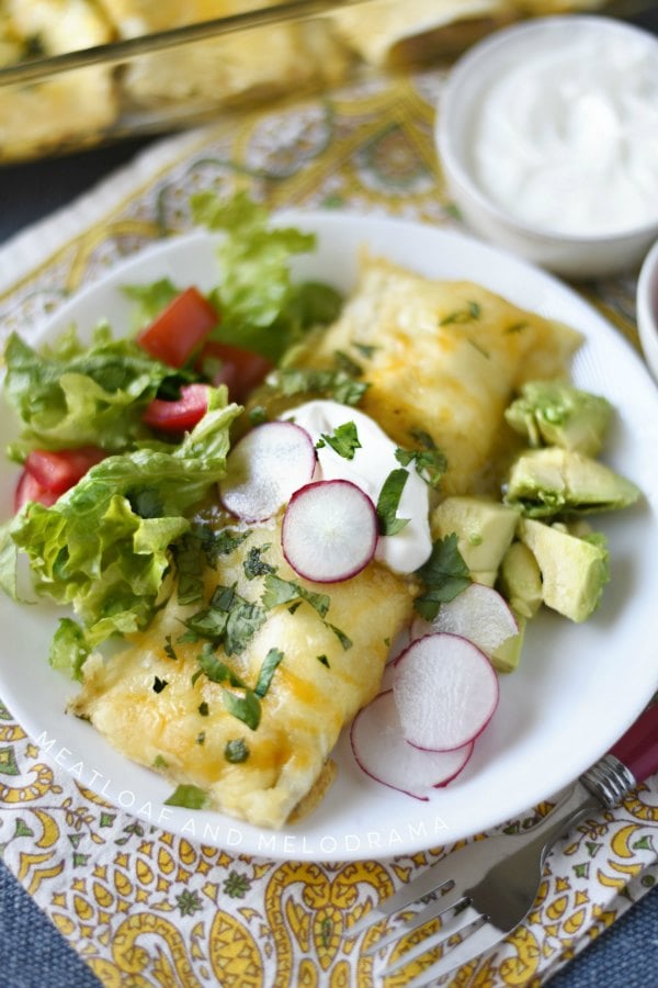 instant pot creamy chicken enchilada with sour cream and radishes, tomatoes and avocado on white plate