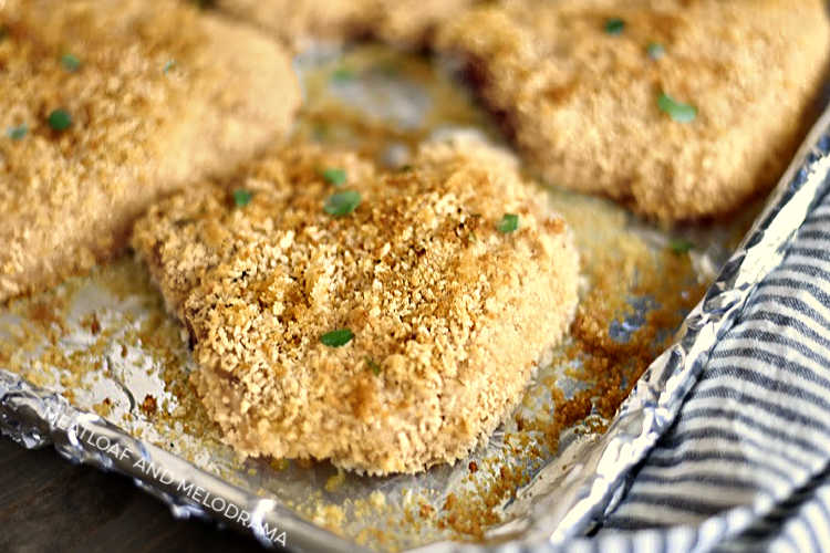 crispy baked breaded pork chops with panko on baking sheet