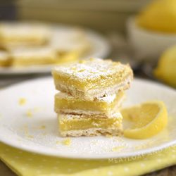 easy lemon bars with shortbread crust and powdered sugar topping on white plate