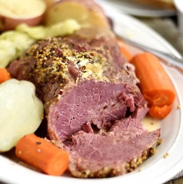 instant pot corned beef and cabbage with carrots and red potatoes on white platter