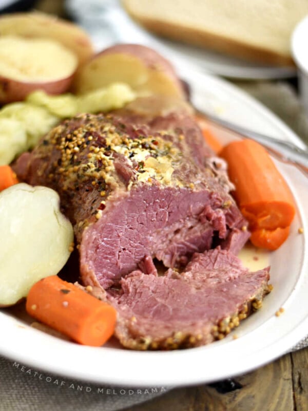 instant pot corned beef and cabbage with carrots and red potatoes on white platter