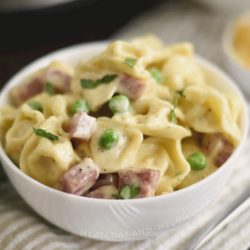 instant pot ham and cheese tortellini with peas in a white bowl