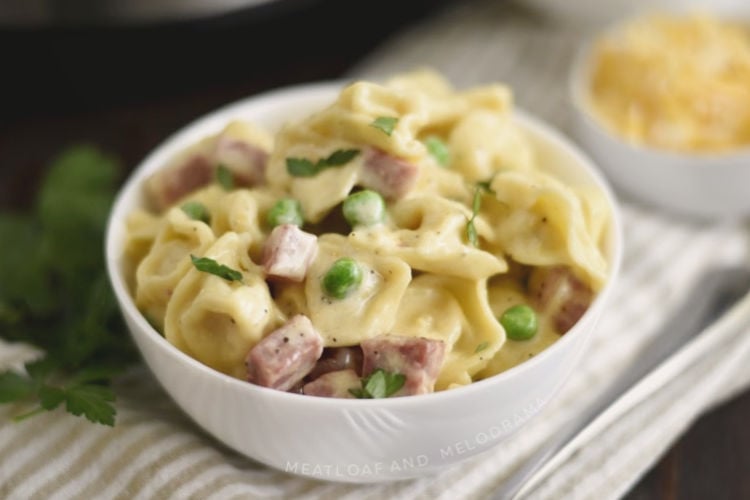 instant pot ham and cheese tortellini with peas in a white bowl