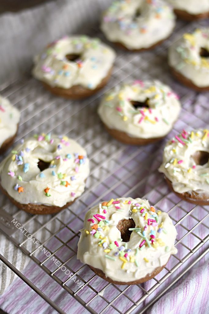 easy carrot cake donuts with cream cheese frosting and sprinkles on baking rack