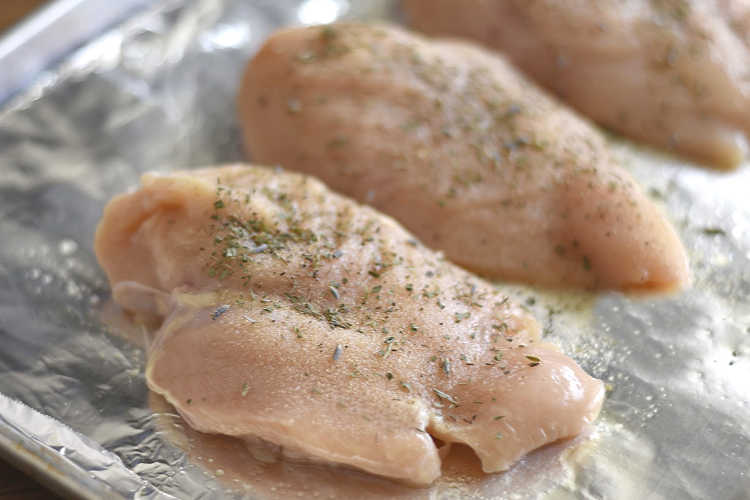 boneless skinless chicken breasts on a baking sheet