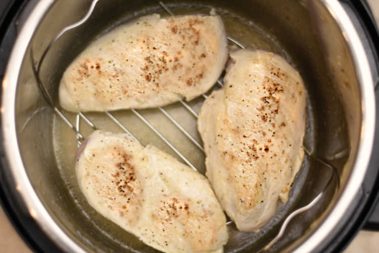 cooked chicken breasts on trivet in instant pot