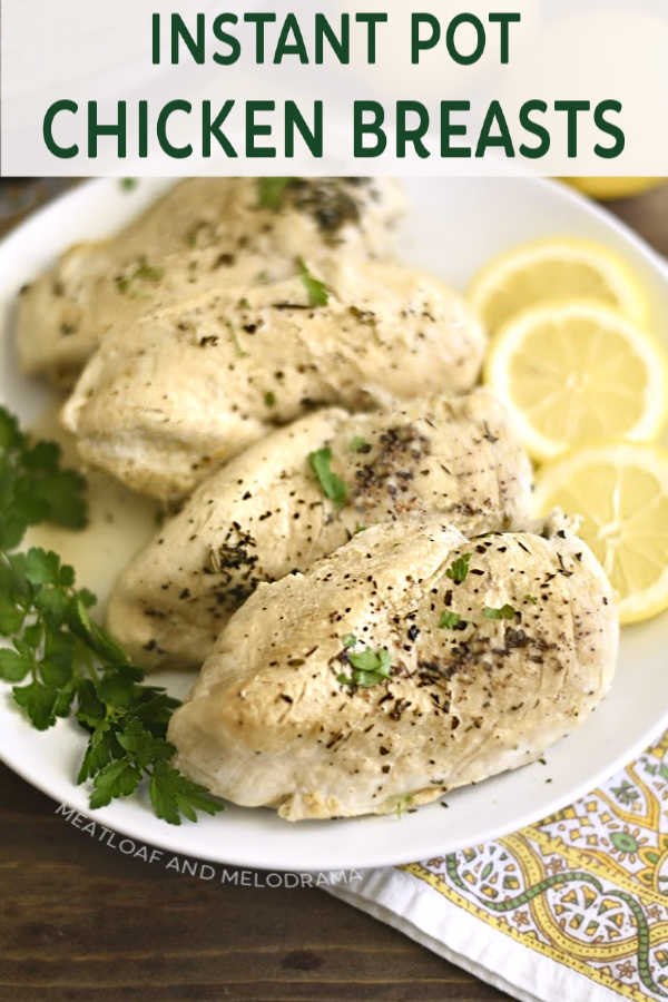 pressure cooker chicken breasts on platter with lemon and parsley