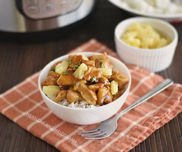 instant pot hawaiian bbq chicken over rice in a bowl with pineapples