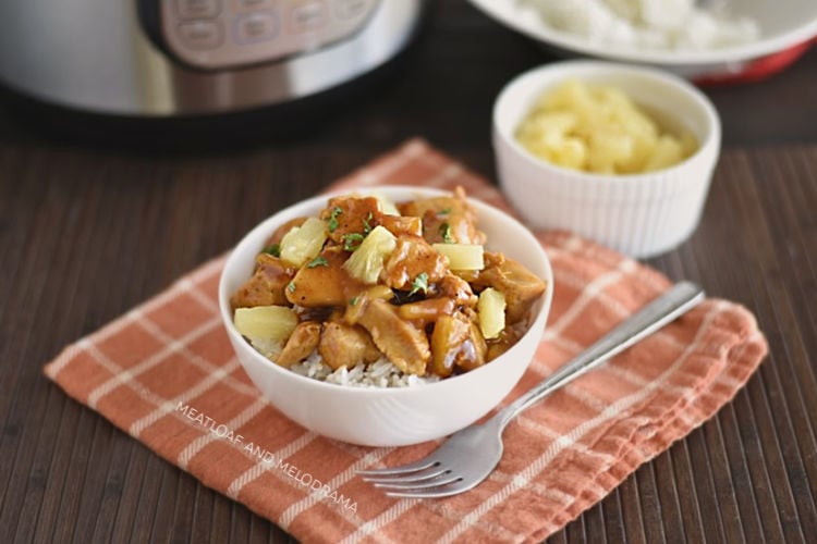 instant pot hawaiian bbq chicken over rice in a bowl with pineapples