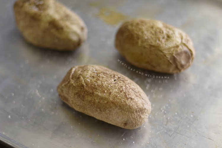 baked russet potatoes on baking sheet with sea salt 