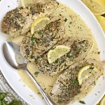instant pot creamy lemon garlic chicken breasts with lemon slices on white platter