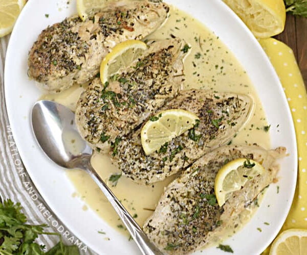 instant pot creamy lemon garlic chicken breasts with lemon slices on white platter