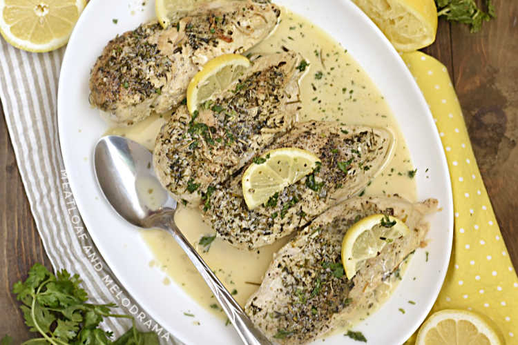 instant pot creamy lemon garlic chicken breasts with lemon slices on white platter