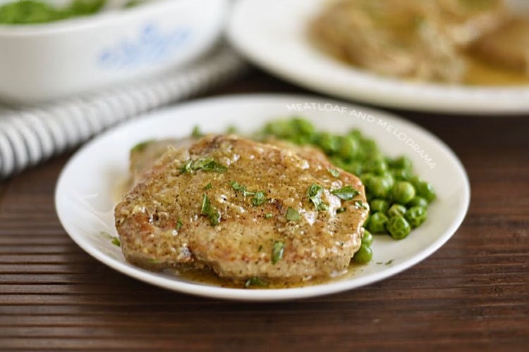 instant pot boneless pork chops on a plate with gravy and peas