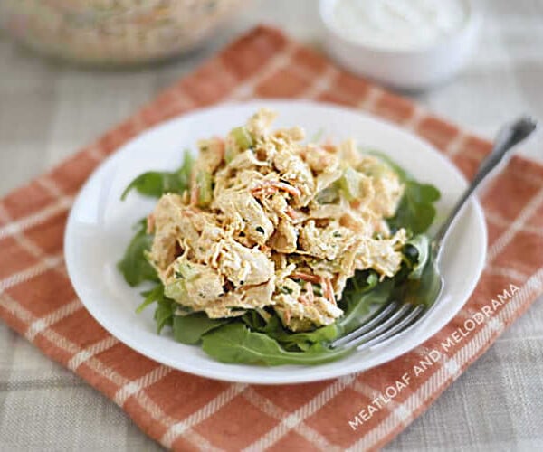 Instant Pot buffalo chicken salad over arugula on a white plate