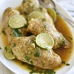 instant pot honey lime chicken breasts on white platter with lime slices