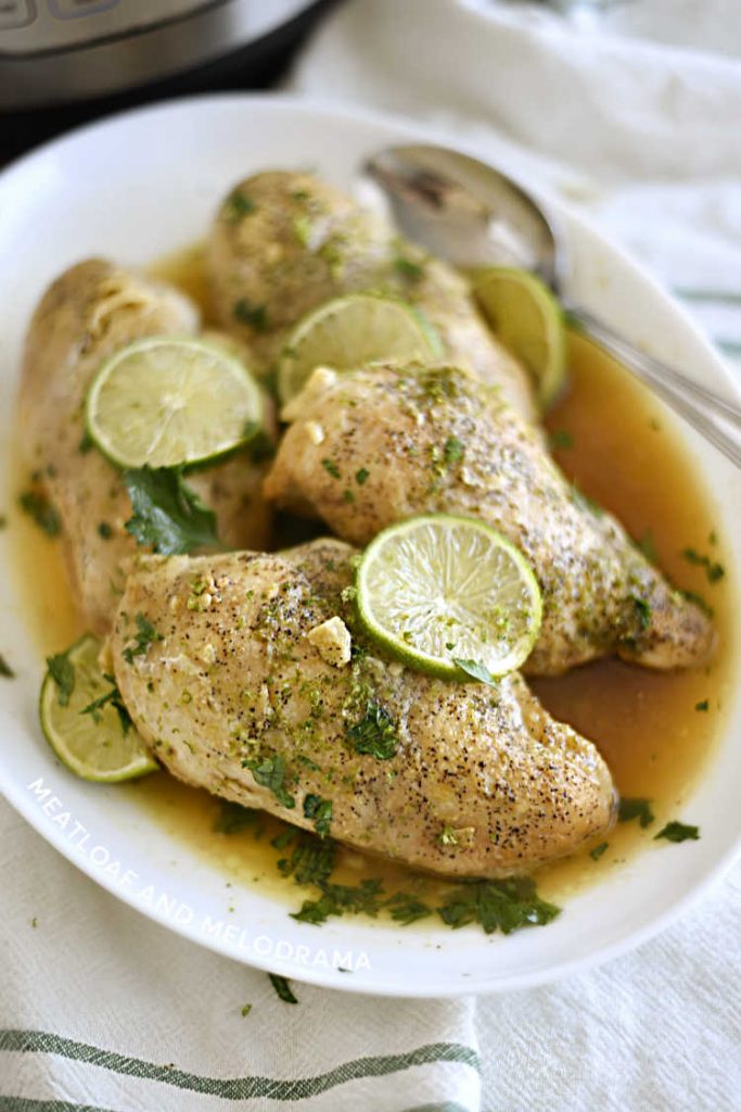 instant pot honey lime chicken breasts on white platter with lime slices