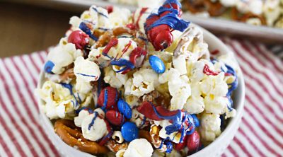 patriotic popcorn pretzel snack mix in white bowl