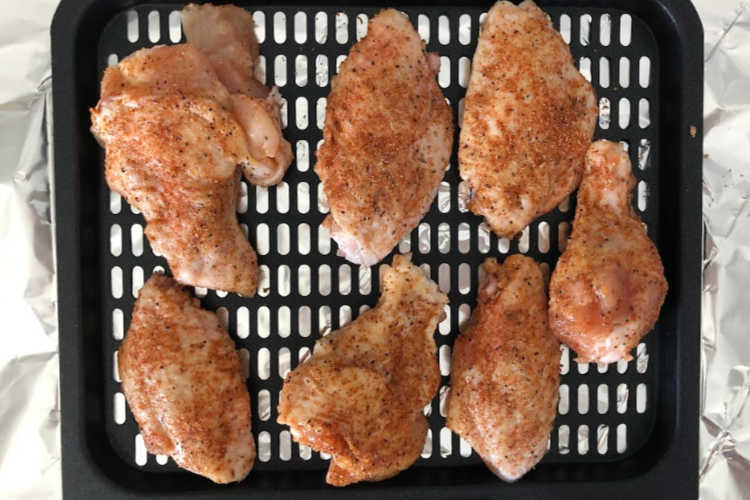 chicken wings seasoned with bbq dry rub on air fryer cooking rack