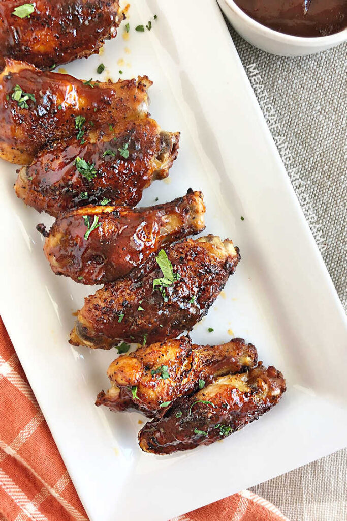 air fryer chicken wings with bbq sauce on white tray