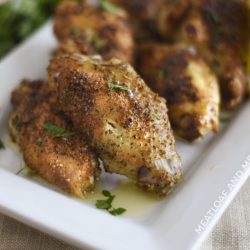 crispy air fryer garlic herb chicken wings on a white platter