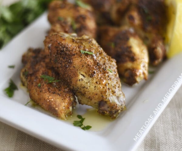 crispy air fryer garlic herb chicken wings on a white platter