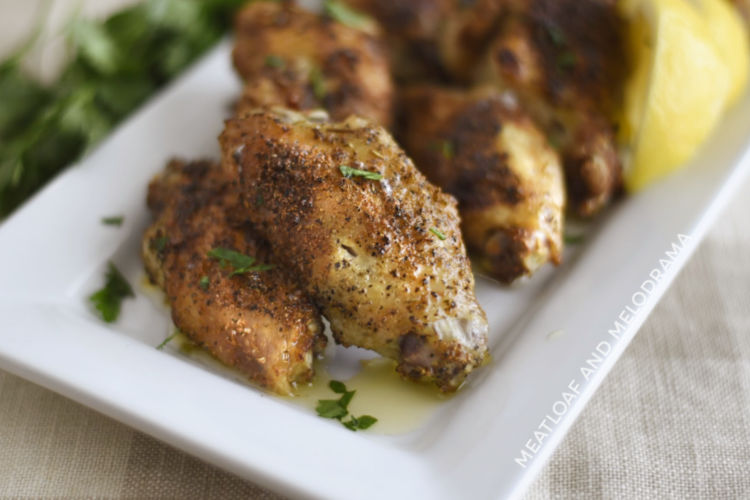 crispy air fryer garlic herb chicken wings on a white platter