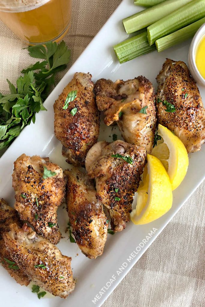 air fryer chicken wings with lemon and celery sticks on platter