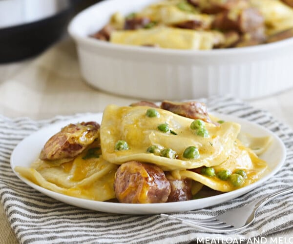 instant pot pierogi casserole with kielbasa and peas on a white plate