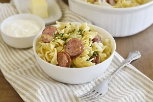 instant pot cabbage and noodles and kielbasa in white bowl