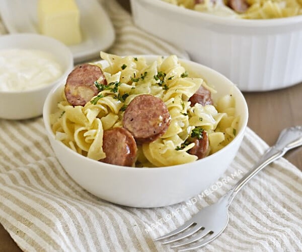 instant pot cabbage and noodles and kielbasa in white bowl