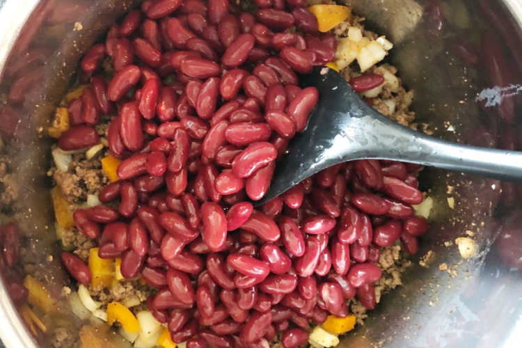 layer chili ingredients and kidney beans in the instant pot