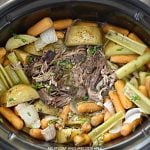 shredded fall apart chuck roast with potatoes, carrots and celery in the crock-pot
