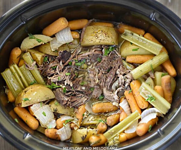 shredded fall apart chuck roast with potatoes, carrots and celery in the crock-pot