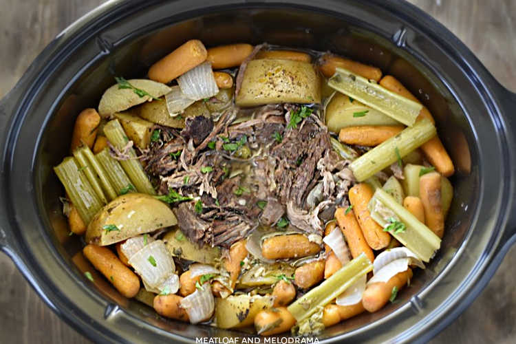 shredded fall apart chuck roast with potatoes, carrots and celery in the crock-pot