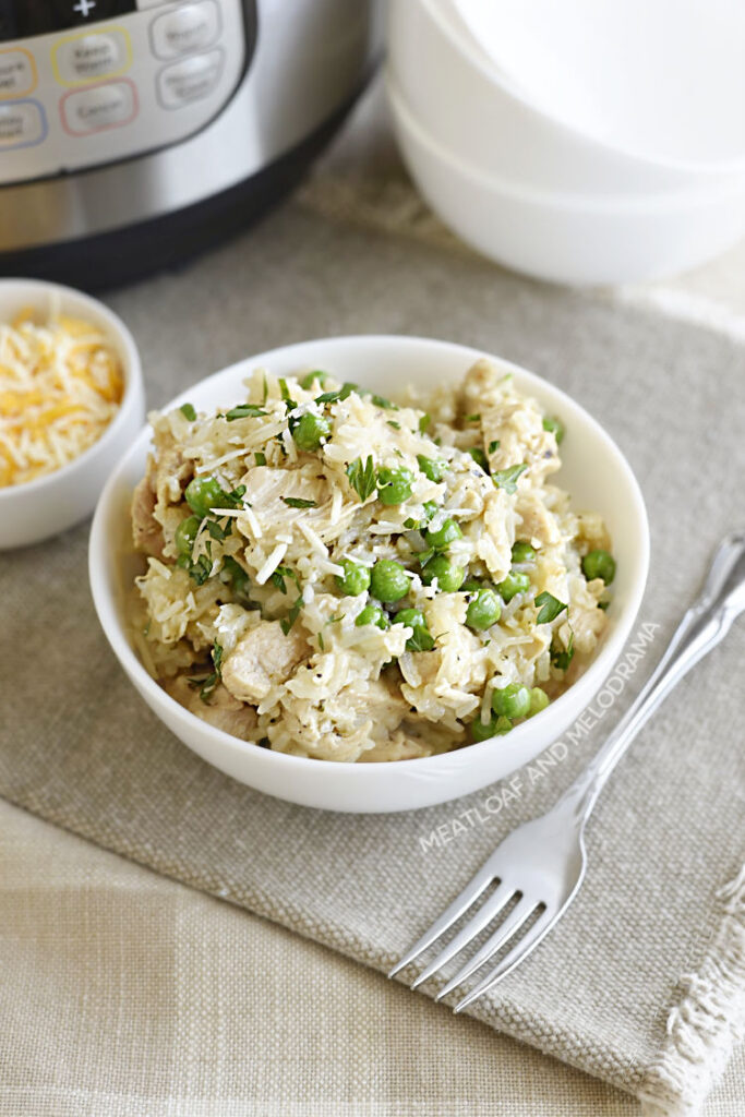 pressure cooker chicken and rice with peas in a white bowl